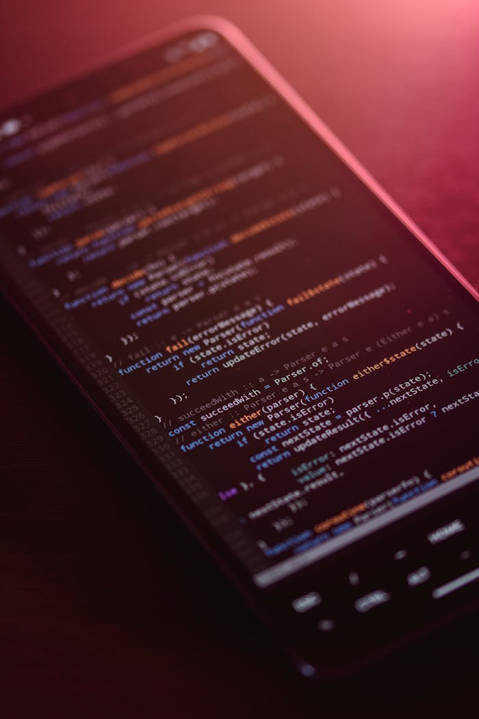 gallery-3 Colorful code displayed on a smartphone screen with a warm glow.